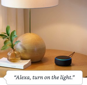 Side table with a lamp and a black Echo Dot device.